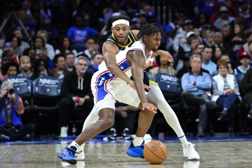 Tyrese Maxey being guarded by Bruce Brown.