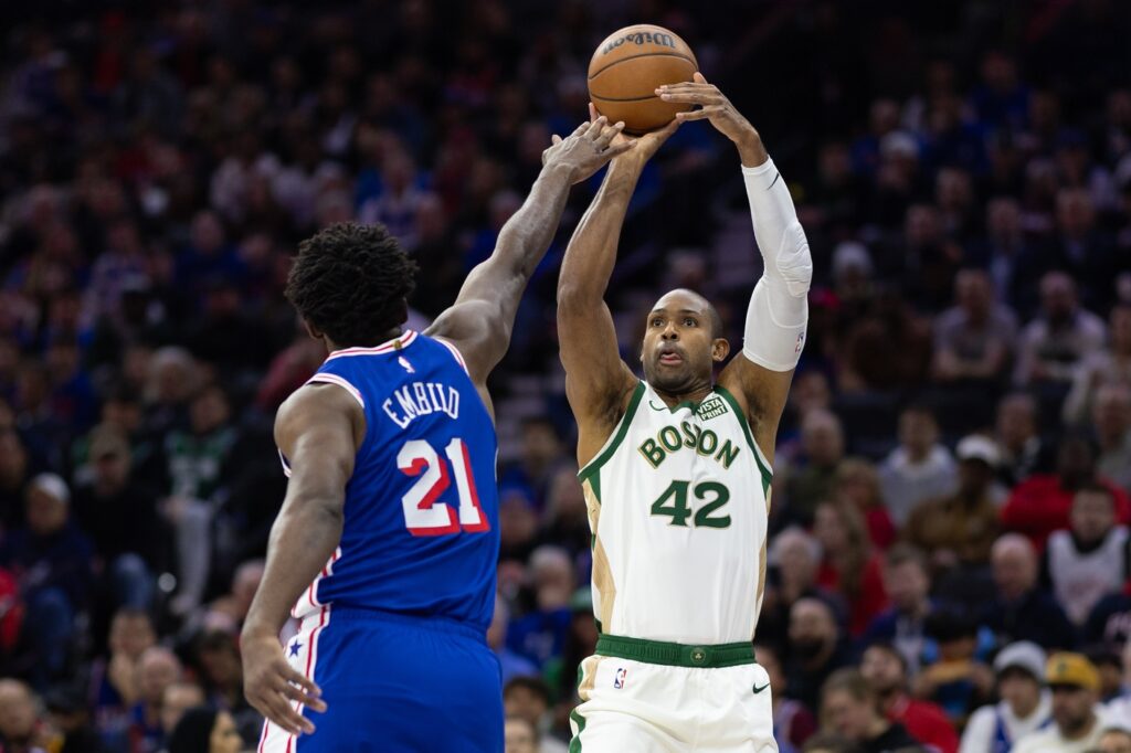 Joel Embiid closing out on Celtics center Al Horford.