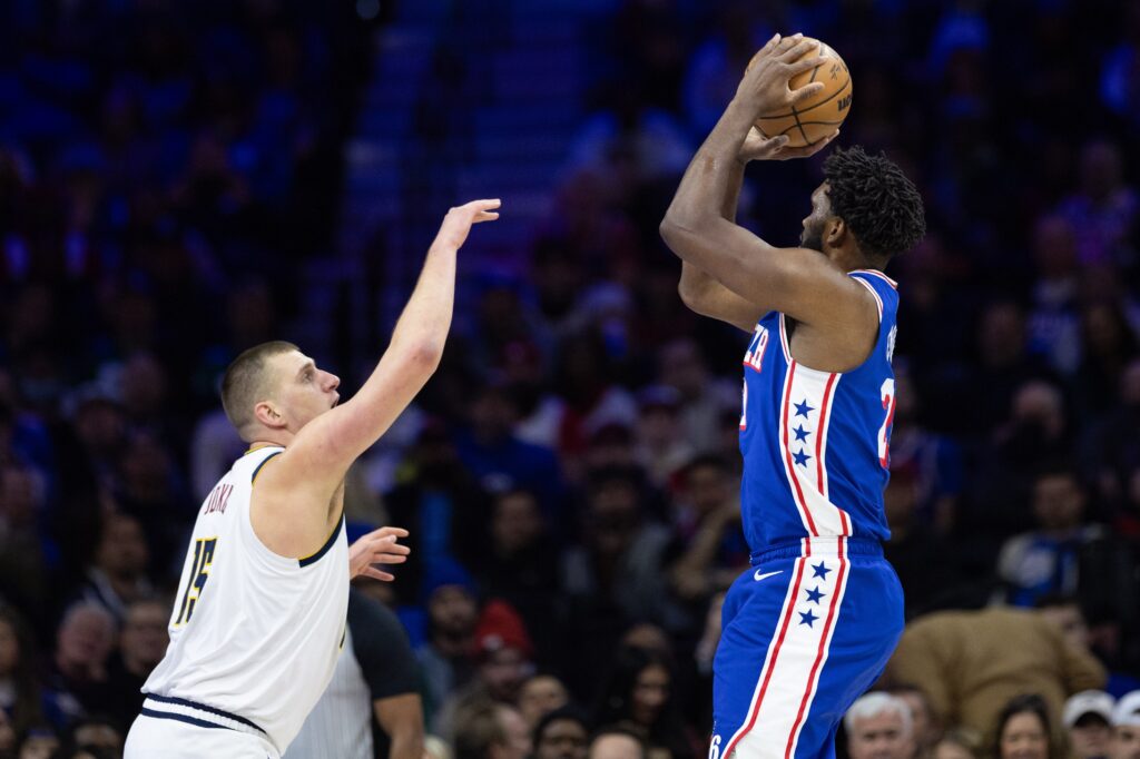 Joel Embiid shots over Nikola Jokic.