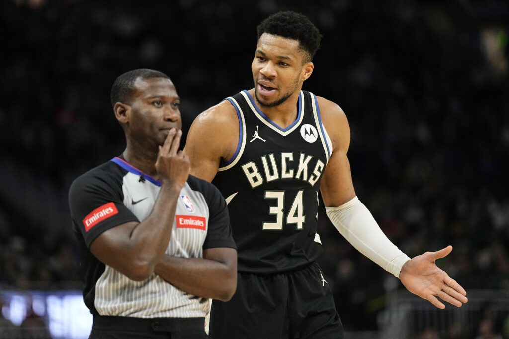 Giannis huddling with one of his teammates.