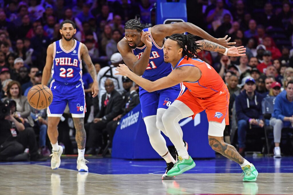 Joel Embiid scrambles for a loose ball.