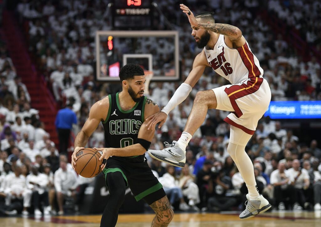 Caleb Martin karate kicking Jayson Tatum.