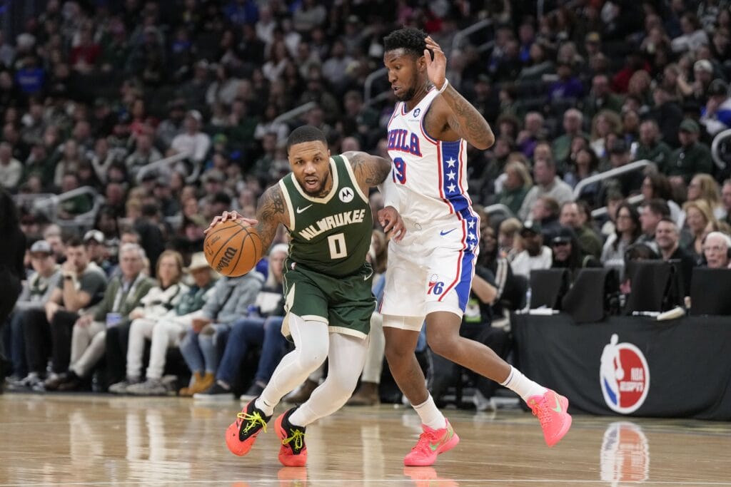 Damian Lillard drives past Justin Edwards.