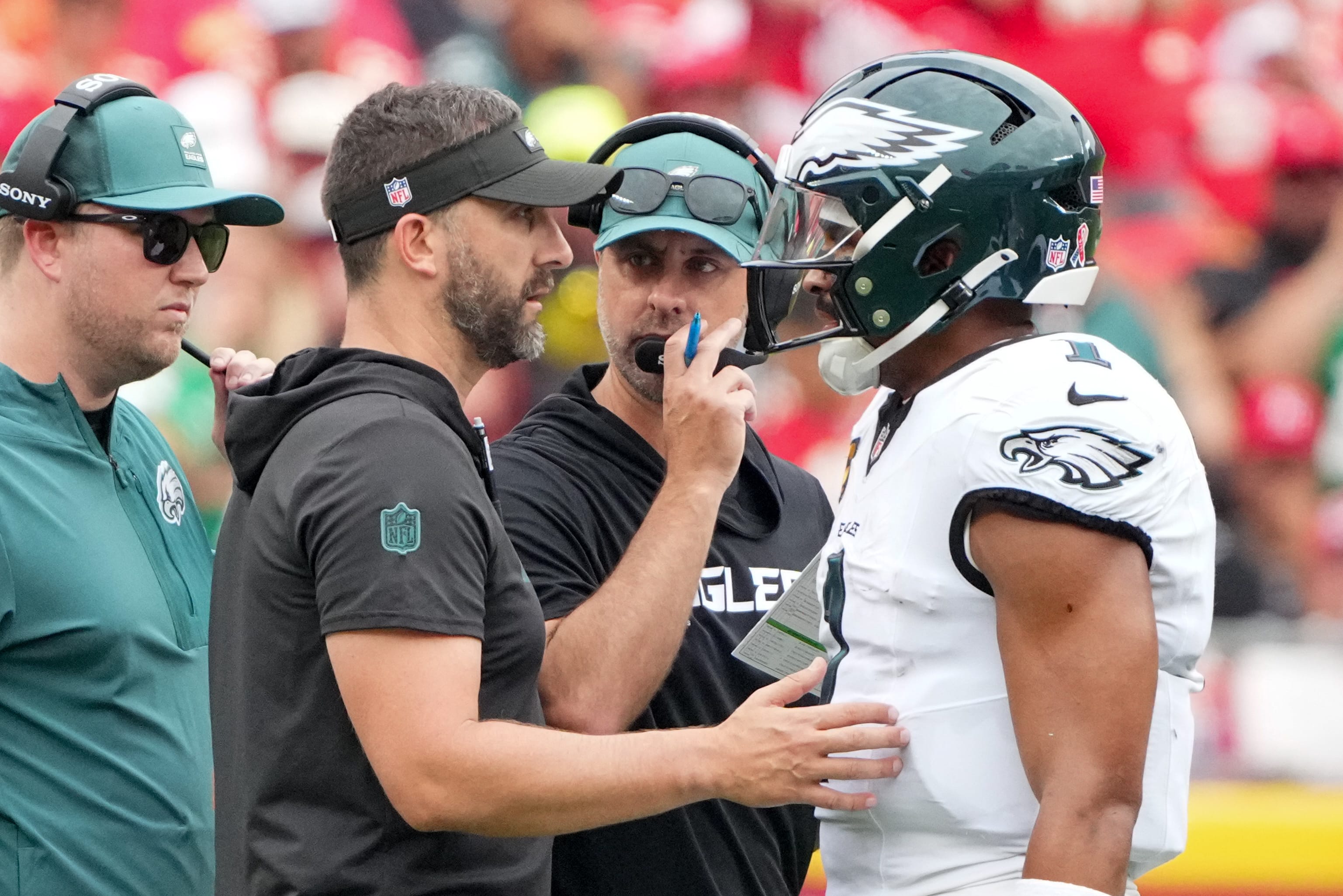 Eagles head coach Nick Sirianni and offensive coordinator Kevin Patullo speak with Philadelphia Eagles quarterback Jalen Hurts (1) during the second quarter of the game against the Kansas City Chiefs at GEHA Field at Arrowhead Stadium. Mandatory Credit: Denny Medley-Imagn Images