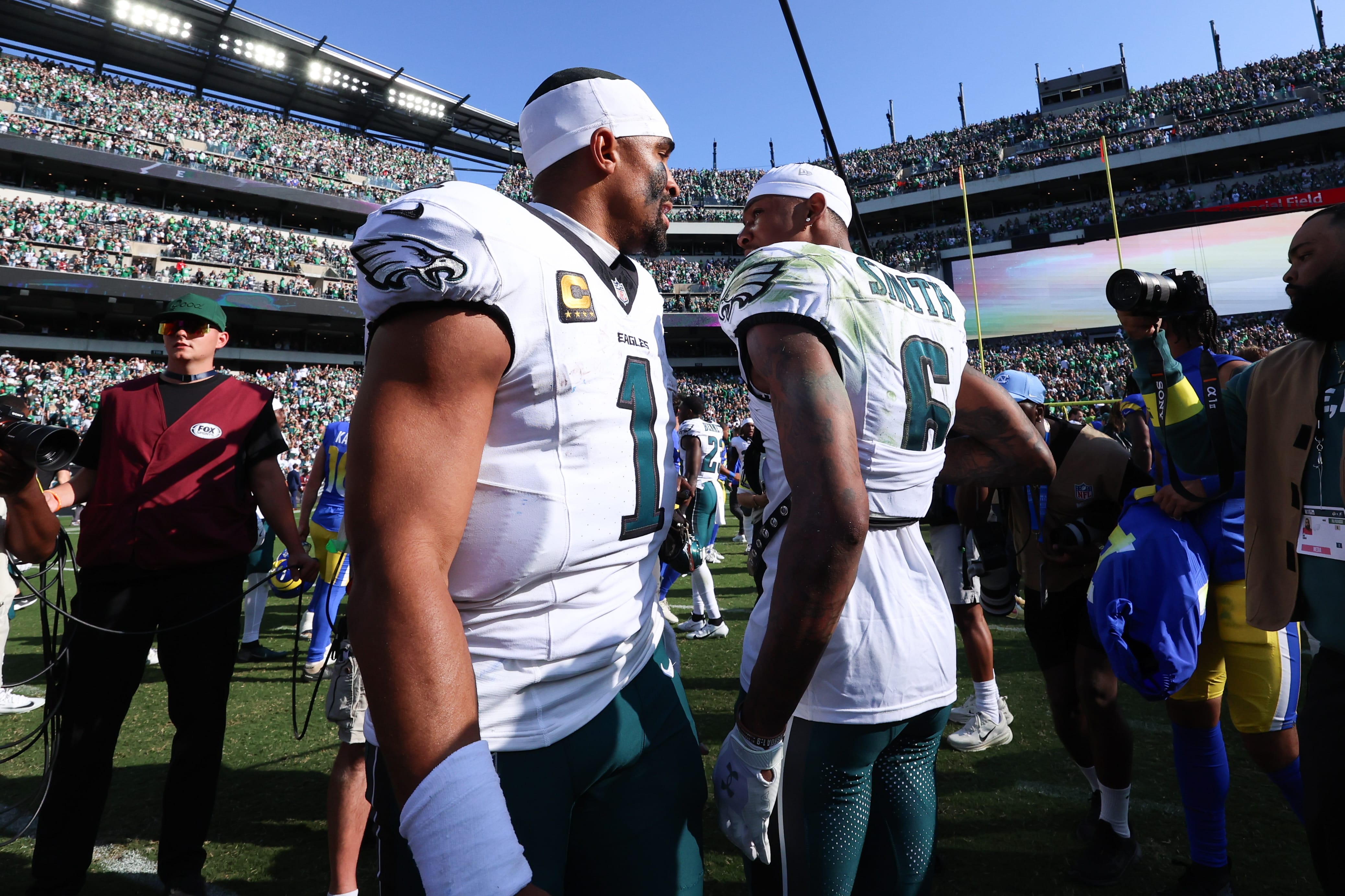 Eagles quarterback Jalen Hurts (1) and wide receiver Devonta Smith (6) after a victory against the Los Angeles Rams at Lincoln Financial Field. Mandatory Credit: Bill Streicher-Imagn Images