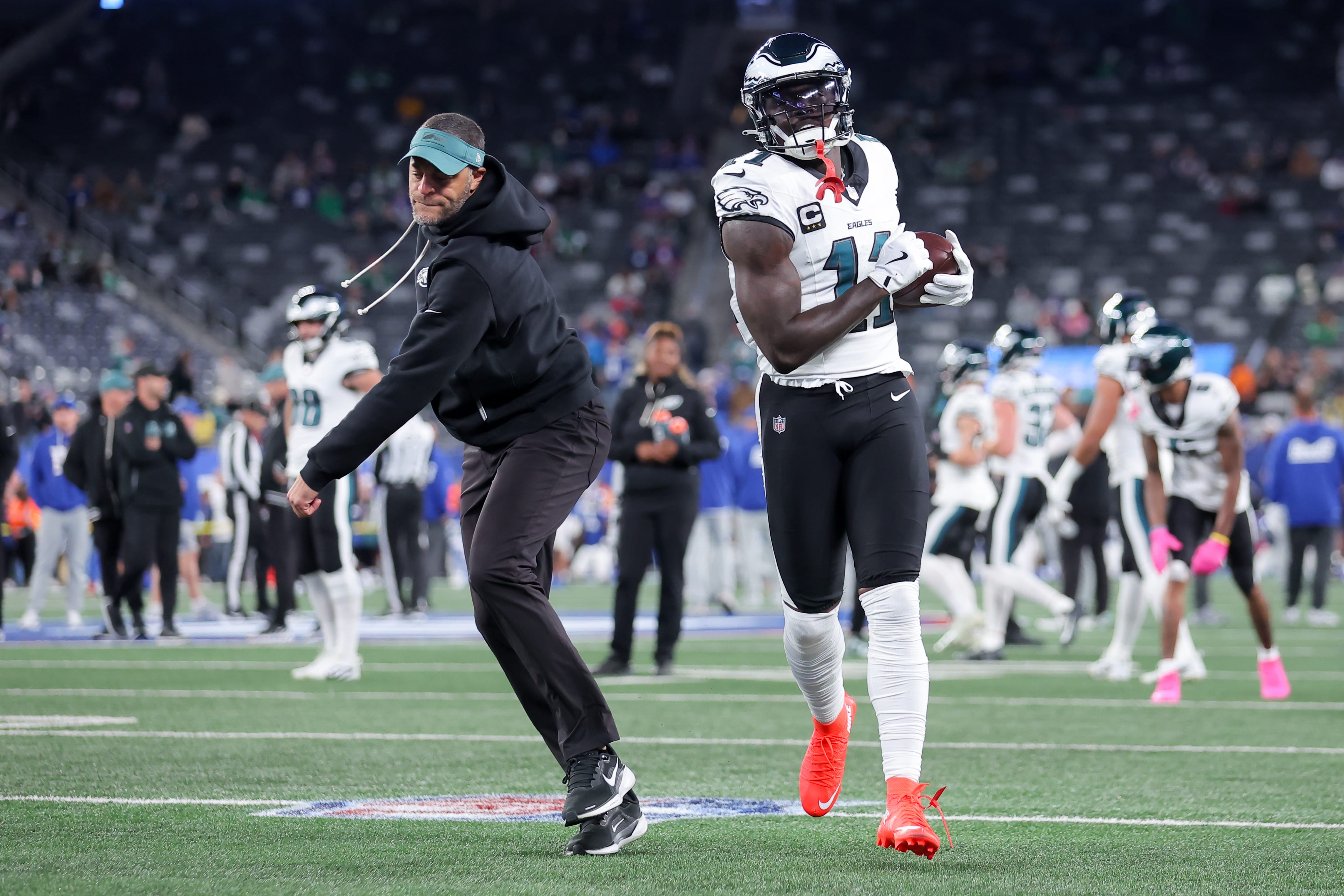 Eagles wide receiver A.J. Brown (11) warms up with wide receivers coach Aaron Moorehead prior to the game against the New York Giants at MetLife Stadium. Mandatory Credit: Brad Penner-Imagn Images