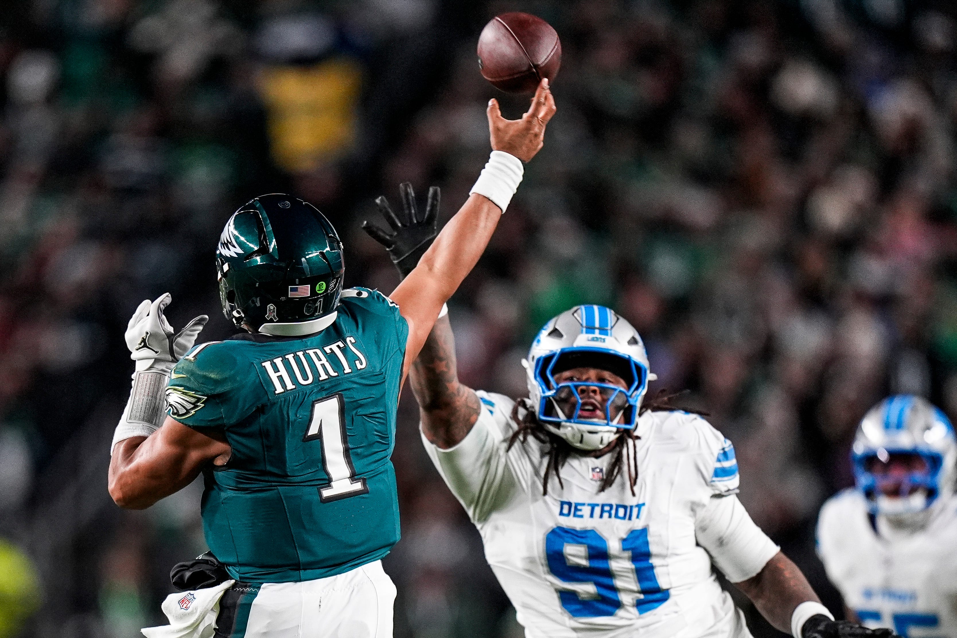 Detroit Lions defensive tackle Tyleik Williams tries stop a pass from Philadelphia Eagles quarterback Jalen Hurts during the second half at Lincoln Financial Field in Philadelphia on Sunday, November 16, 2025.
