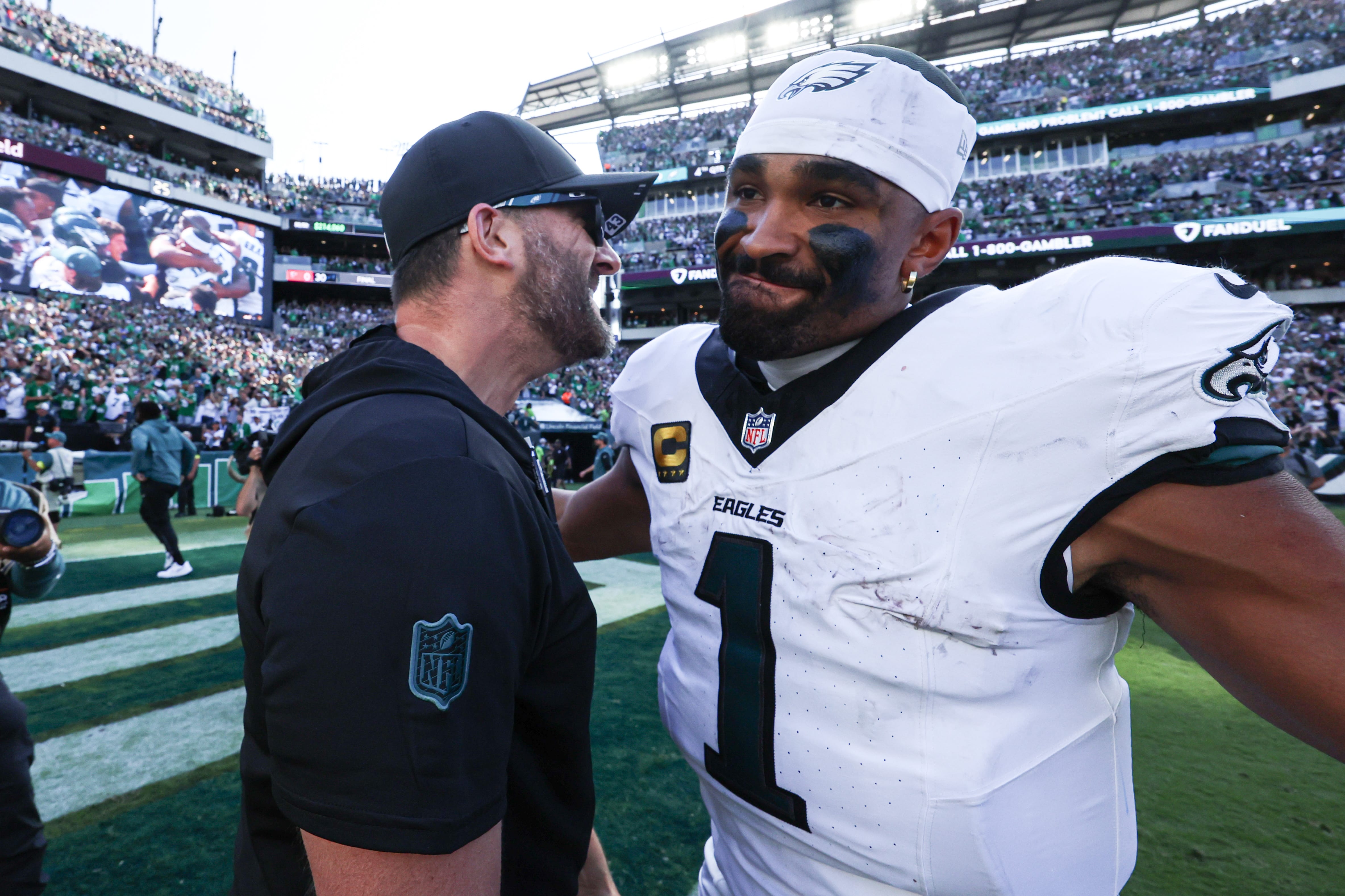 Eagles quarterback Jalen Hurts (1) and head coach Nick Sirianni celebrate after a victory against the Los Angeles Rams at Lincoln Financial Field. Mandatory Credit: Bill Streicher-Imagn Images
