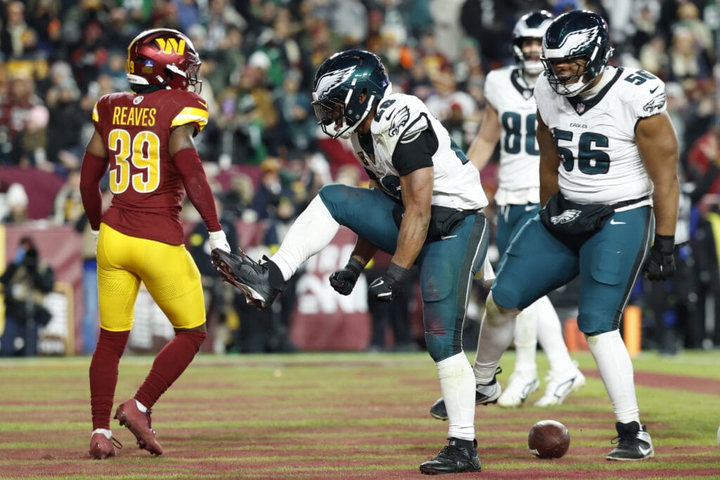 Eagles running back Saquon Barkley (26) celebrates after scoring a touchdown against the Washington Commanders in the second half at Northwest Stadium. Mandatory Credit: Geoff Burke-Imagn Images