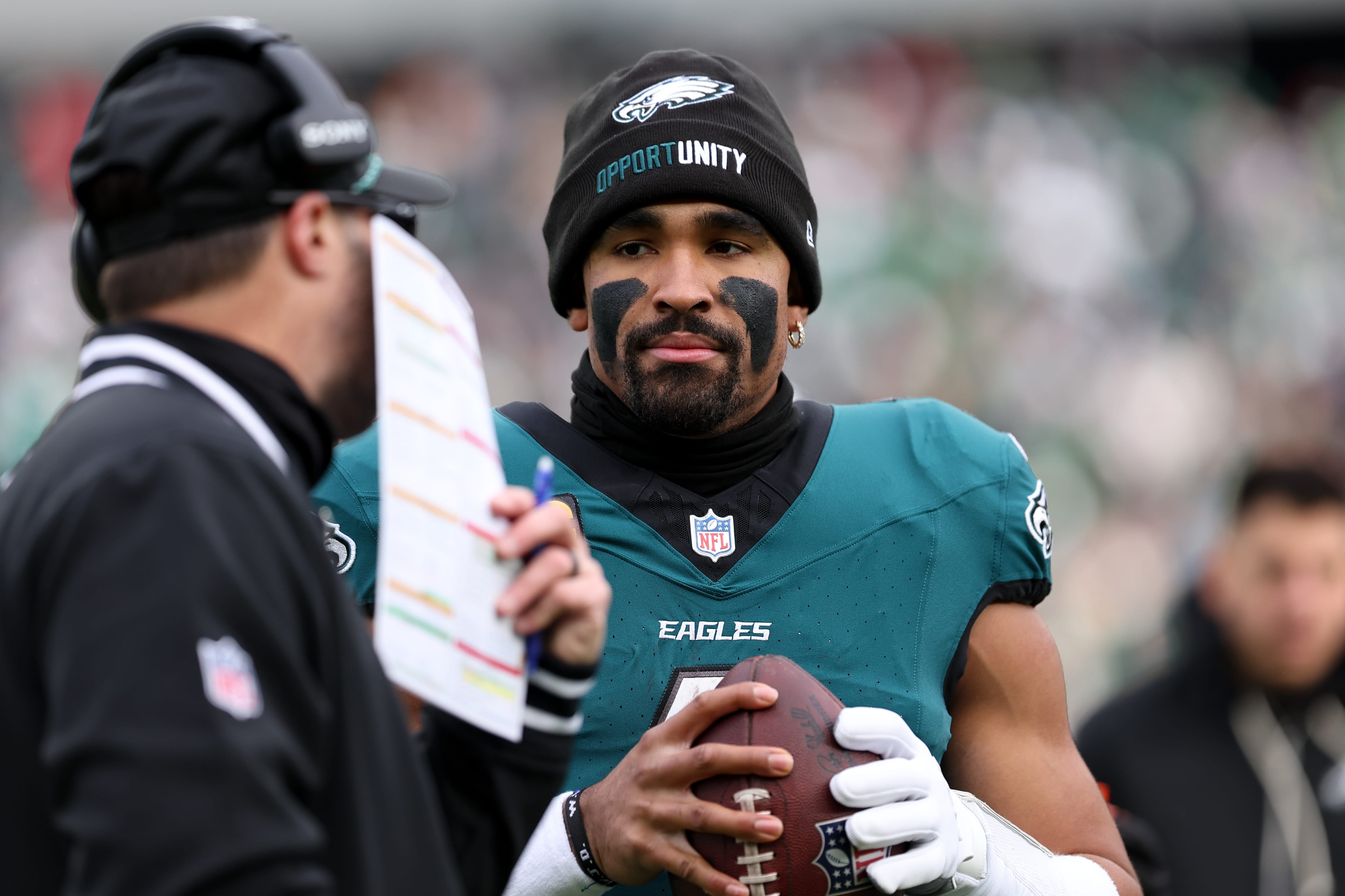 Eagles quarterback Jalen Hurts (1) speaks with offensive coordinator Kevin Patullo (left) during the first quarter against the Las Vegas Raiders before taking a possession at Lincoln Financial Field. Mandatory Credit: Bill Streicher-Imagn Images