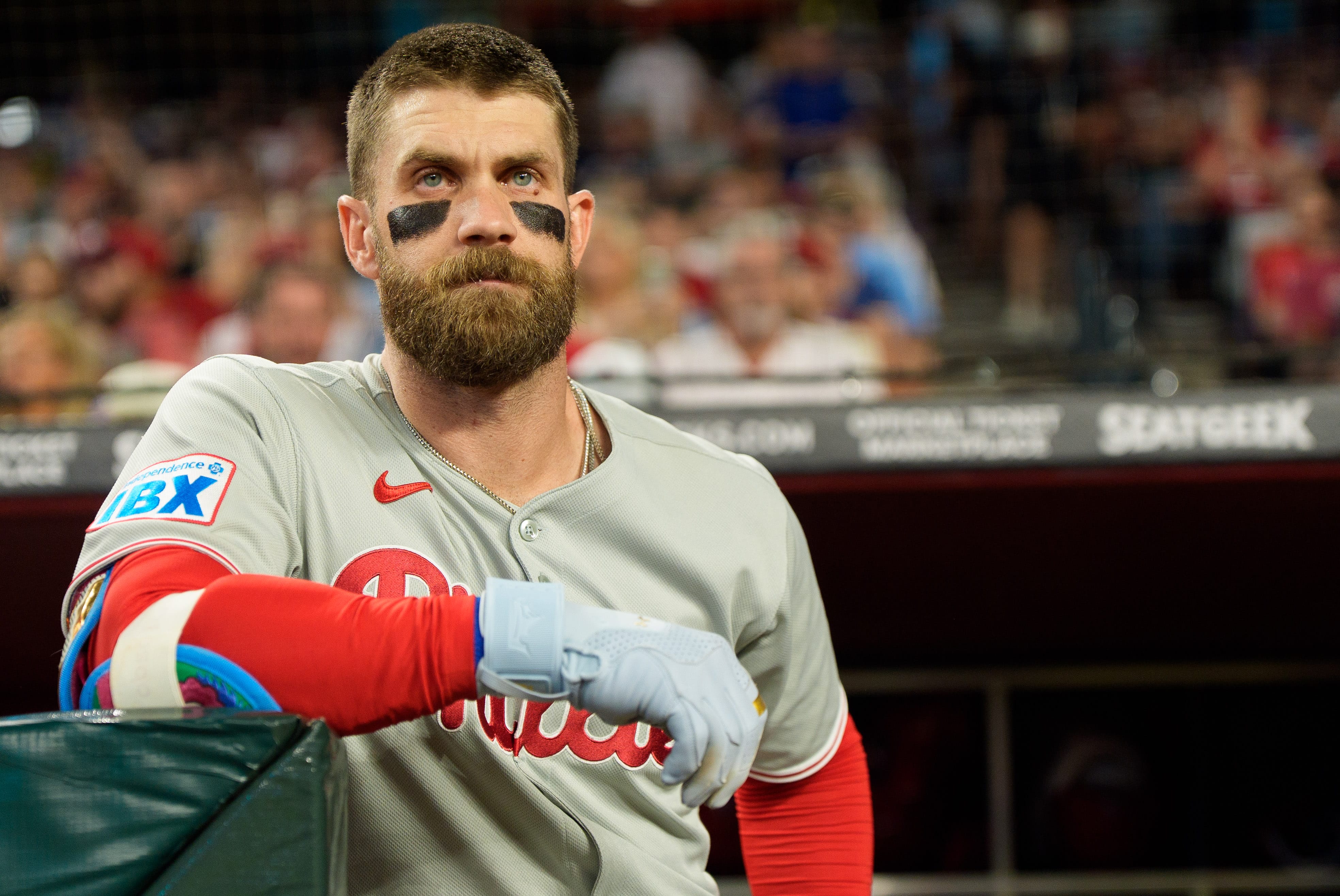 Phillies infielder Bryce Harper (3) watches on from the dugout before his first at bat of the game against the Arizona Diamondbacks at Chase Field. Mandatory Credit: Allan Henry-Imagn Images