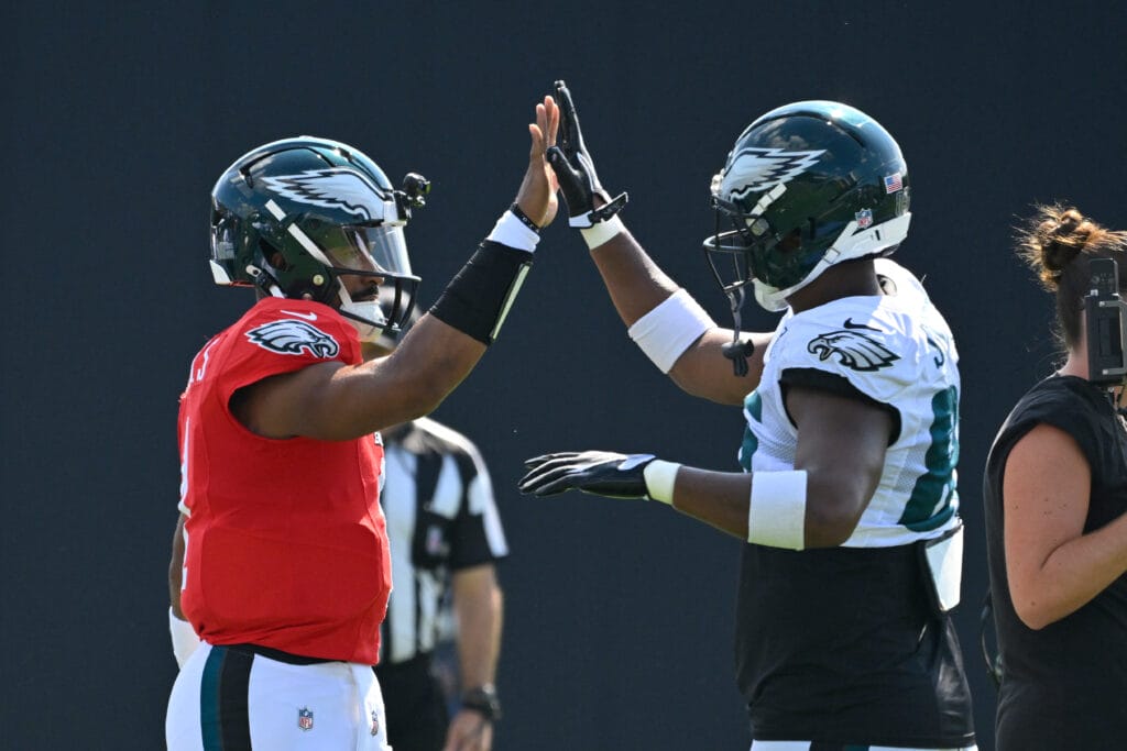 Philadelphia Eagles quarterback Jalen Hurts (1) high-fives tight end Stone Smartt (85) during training camp at Gillette Stadium. Mandatory Credit: Eric Canha-Imagn Images