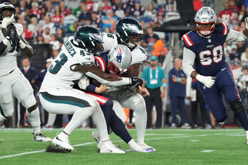 Eagles linebacker Jose Ramirez (43) and linebacker Joshua Weru (46) sack New England Patriots quarterback Behren Morton (15) during the second half at Gillette Stadium. Mandatory Credit: Gregory Fisher-Imagn Images