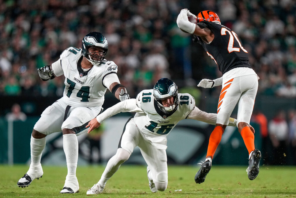 Philadelphia Eagles quarterback Tanner McKee (16) trips up Cincinnati Bengals cornerback Tacario Davis (20) after throwing an interception in the second quarter of the NFL Preseason Week 3 game between the Philadelphia Eagles and the Cincinnati Bengals at Lincoln Financial Field in Philladelphia on Friday, Aug. 28, 2026.
